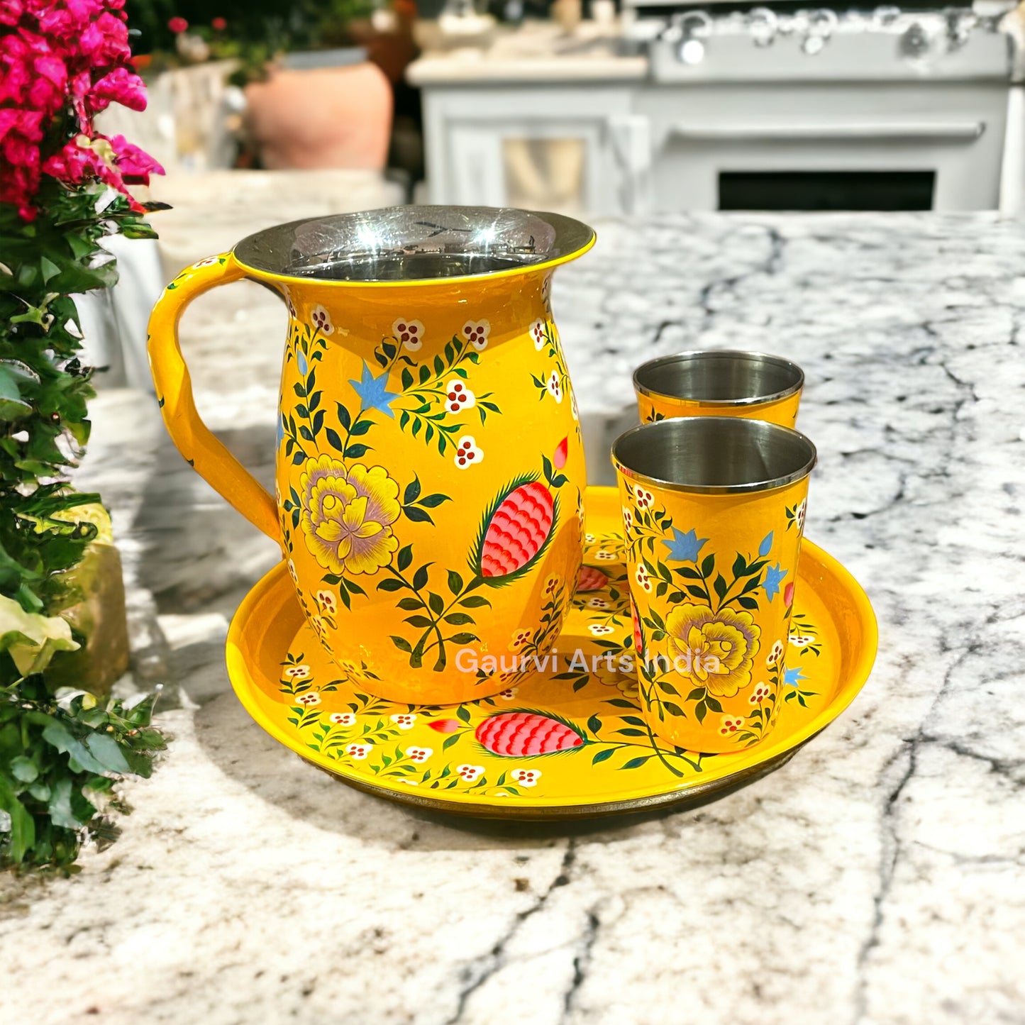 Stainless steel pitcher set includes a sleek pitcher, matching tumblers, and a round tray, designed for everyday use.